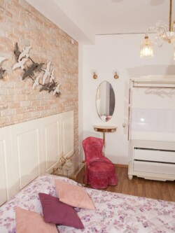 bedroom with mirror and armchair